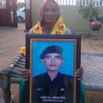Sapper Mahipal Singh's mother Smt Marwan Devi with the photo of her son