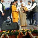 Smt. Rajmani Devi, wife of Naik Arvind Prasad Singh, receiving a memento in his honour.