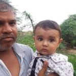 Sep Puspendra Singh's father holding his 7 month old son
