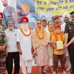 Lance Naik Sandeep Singh's family being felicitated in an event in 2022
